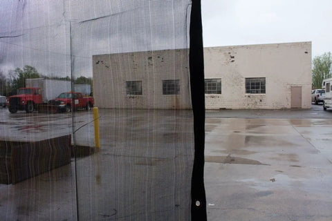 10x16 Foot 10oz Multi Mesh Tarp PVC Coated Polyethylene Shade Roll Off Heavy Duty Black Mesh 50 Percent Shade installed outdoors