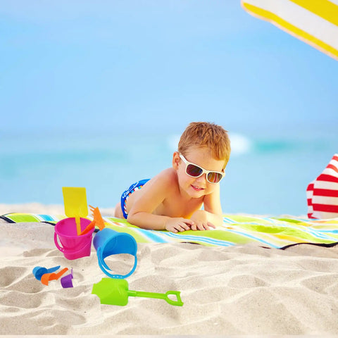 Child playing with Six Pack Mini Beach Bucket Sets With Sand Buckets Shovels Rakes And Scoops Ideal Party Favors For Kids on the beach