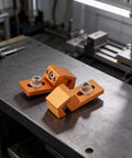 Heavy Duty Low Profile Cnc Side Pressure Plate Kit With T Track Claw Clamps For 3018 Router showing orange aluminum clamps on work surface.