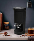 Kick Your Morning Brew Up Automatic Coffee Tamper With Digital Pressure Gauge For Espresso Machines 58MM tamping base on kitchen counter.
