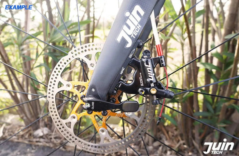 Close-up of a front hydraulic disc brake on a flat mount road gravel bike showcasing the caliper set installation detail.