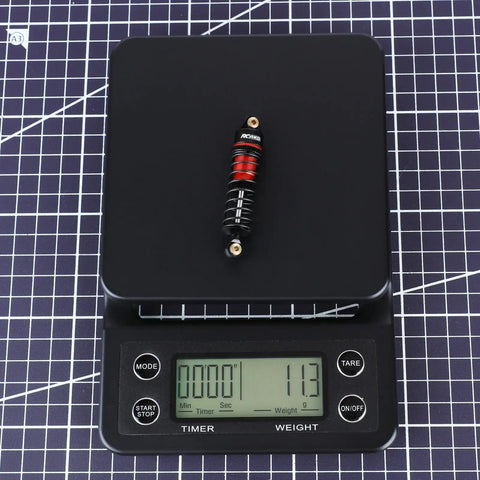 ARRMA Grom Shock Absorber Kit With 3 Spring Options red shock absorber on digital scale showing weight 11.3 grams
