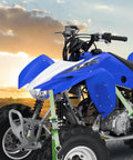Heavy Duty Ratchet Tie Down Straps Workhorse Cinch Lockdown 1500 Lbs Break Strength 1 Inch By 15 Feet securing blue ATV in sunset.