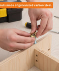 Hand installing Durable M6 Barrel Nut Set With Cross Dowel Joint Nuts For Furniture Repair into wood, tools visible