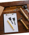 Spare Tire Mounting Hardware Bolt Clamp Adapter for Honda Civic and HRV with clipboard and tools on wooden workbench