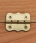 Brass 90 Degree Stop Hinges Set Of Two For Doors And Cabinets installed on wooden surface, showing decorative brass finish
