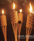 Citronella Bamboo Torches 4 Pack in Brown, 60 Inch Tall outdoor lighting lit at night, close-up view of flames and metal canisters