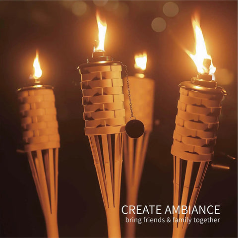 Citronella Bamboo Torches 4 Pack in Brown, 60 Inch Tall outdoor lighting lit at night, close-up view of flames and metal canisters
