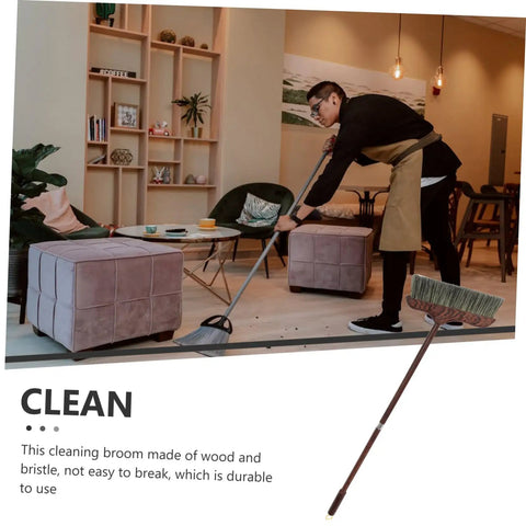 Long Handle Heavy Duty Broom With Soft Beveled Bristles For No Sweat Dust Removal and Quick Corner Cleanup Solid Workhorse in use cleaning indoor space.