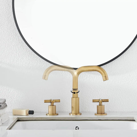 Antique Brass Two Handle Widespread Bathroom Faucet With 3 Holes And 360 Degree Swivel Spout Pop Up Drain Cold And Hot Water Mixer 1.2 GPM High Flow Performance on a white vanity.