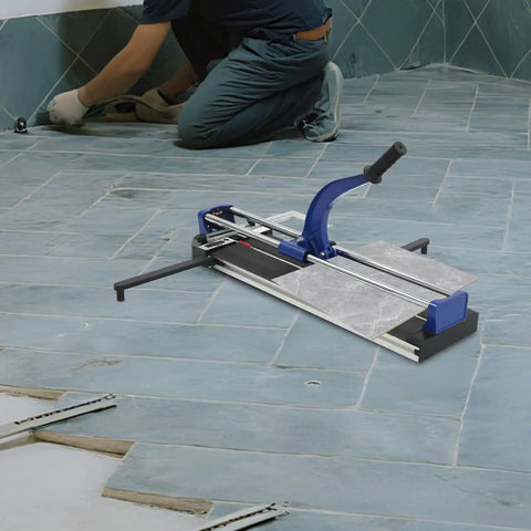 31 Inch Manual Tile Cutter Heavy Duty Precision Scoring Tool With Ball Bearings And Ruler Bar being used to cut tiles on a floor.