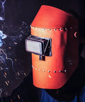 Welding professional using a helmet with premium glass welding lens for safety while cutting and grinding.