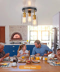 Black And Gold Semi Flush Mount Ceiling Light Three Light Fixture With Clear Glass Shades illuminating a dining room scene
