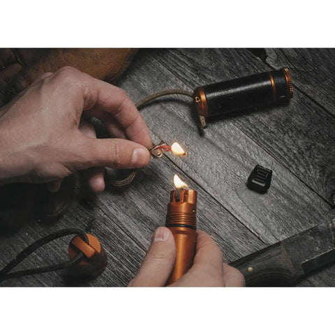 Using Rip Spool Field Repair Kit Orange For On The Go Fixes with a lighter to repair cord for outdoor gear repair on wood surface.