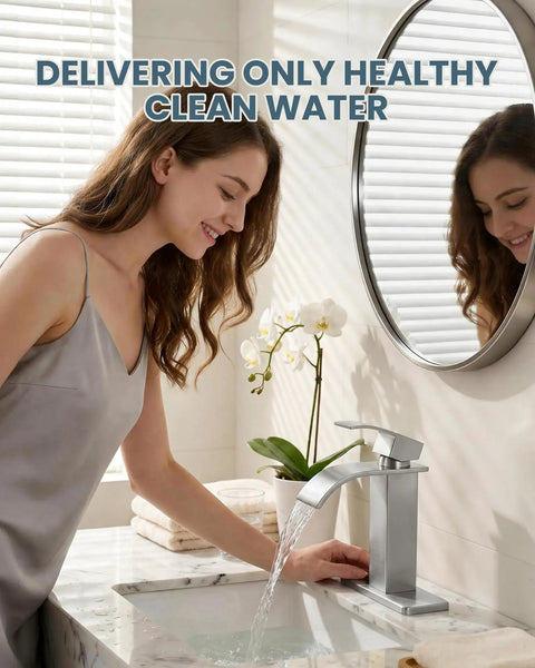 Woman using Waterfall Style Brushed Nickel One Hole Bathroom Sink Faucet With Pop Up Drain And Supply Lines, 3 Hole Compatible