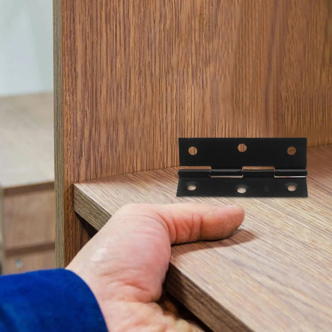 Black Stainless Steel Cabinet Door Hinges With Screws For Easy Opening And Closing Foldable Butt Hinges For Wooden Box Doors No Fuss Furniture Making And Office Use installed on wooden cabinet, showing hand testing hinge movements