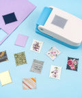 Lever Action Postage Stamp Punch 1x0.8 Inch Rectangular Stamp Shaped Paper Punch on blue background with various cut paper designs.