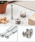 Close-up of 25 sets furniture cam lock fasteners and connecting dowels 50 pieces in clear storage box with wood shavings