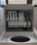 Interior view of Score More Counter Space With This Roomy Portable Countertop Dishwasher filled with plates and spoons.