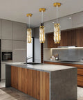 Gold Pendant Lights Set of 2 Dope Crystal Mini Chandelier for Kitchen Island, shown above modern kitchen island with sleek gold fixtures