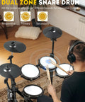 Person playing Electric Drum Set With USB MIDI Dual Power Modes Dual Zone Triggering 64 Polyphony 225 Authentic Sounds