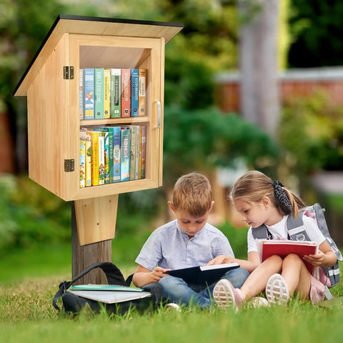 Outdoor Library Book Box With Double Shelf For Book Swapping And Sharing Weatherproof Little Library Cabinet With Shatterproof Clear Door Easy Mount DIY Wooden Storage For Neighborhoods And Schools installed outdoors with children reading nearby.