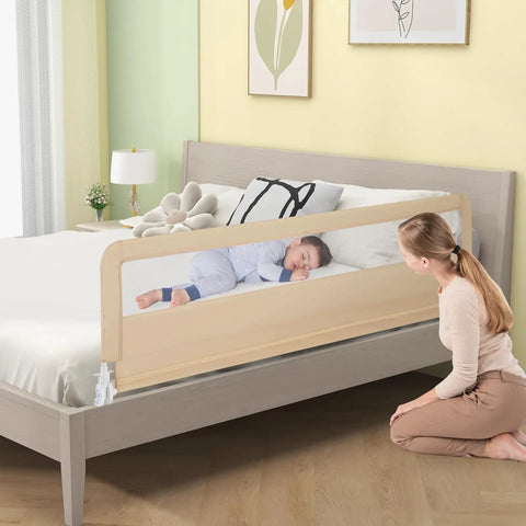 Child sleeping safely beside Foldable Bed Rail For Toddlers And Tots 71 Inch Safety Guard With Straps, beige color.
