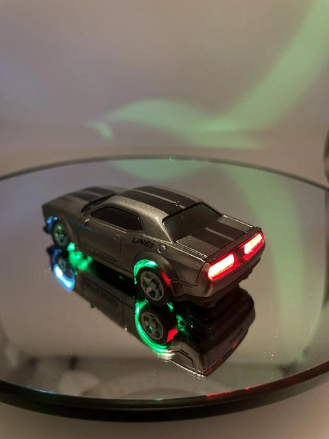 Mini RC Drift Car 1 To 64 Scale With LED Lights 4WD Pro Controls on reflective surface, showing illuminated rear and side LEDs.