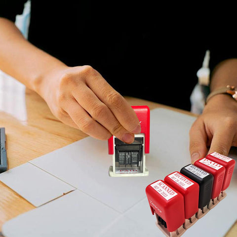 Hand using Slick Adjustable Received Date Stamp For Offices And Businesses Straight Up Reliable Two Color Ink With Blue Text And Bold Red Dates Easy To Reset Up To Thirteen Consecutive Years Built Tough For Daily Mailroom Hustles And Quick Paperwork Sign Offs on a document.