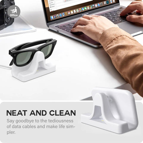 Slick Charging Stand With USB-C Cable For Ray-Ban Meta Smart Glasses Gen 1 And Gen 2 next to laptop on desk