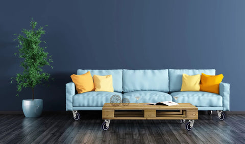 Blue sofa with orange and yellow pillows on 4 inch polyurethane shopping cart wheels pack of four with potted plant, hardwood floor
