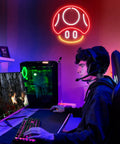 Mushroom Neon Sign For Gaming Room Decor Red LED Wall Light in vibrant game room setup with gamer at computer desk.