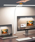 User adjusting LED Clamp Desk Lamp With Gooseneck, Eye Care Desk Light For Home Office on desk next to computer screens
