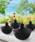 Four Six Pack Metal Table Top Torches With 23.5 Oz Citronella Fuel For Outdoor Parties And Garden Decor on wooden table.