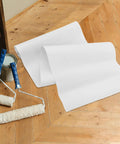 Self Adhesive Kitchen Backsplash Shield And Heat Resistant Clear Plastic Film Wrap For Cupboards on wooden floor with paint tools.
