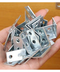 Hand holding multiple Beefy L Shaped Corner Brackets For Shelves Heavy Duty Metal Wall Mount Supports, steel construction, close-up view.