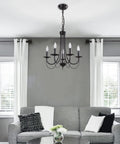 Dope Five Light Farmhouse Chandelier Black Candle Style Ceiling Light Fixture in living room with sofas and curtains