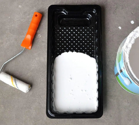 Disposable 4 Inch Paint Tray Liners 12 Pack Mini Plastic Trays Liner Set For Small Projects And DIY Painting Easy Cleanup No Mess Includes 1.5 Inch Brush Thick Durable Plastic For Fast Pro Style Results shown filled with white paint.