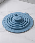 Bekecidi Bathtub Drain Cover, 6-Inch Silicone Tub Stopper, 3 Pack in blue with animal face design, sitting on a marble surface.