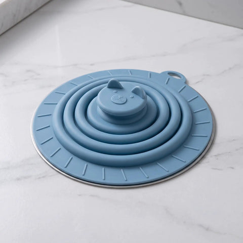 Bekecidi Bathtub Drain Cover, 6-Inch Silicone Tub Stopper, 3 Pack in blue with animal face design, sitting on a marble surface.