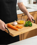 Person holding a bamboo serving tray with Heavy Duty Matte Black Iron Pulls For Cutting Boards And Serving Trays 8 Pack cabinet hardware.