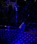 Bluetooth Motion Laser Lights With Dope 7 Color Full Spectrum White Star Effects illuminating stairs outdoors at night.