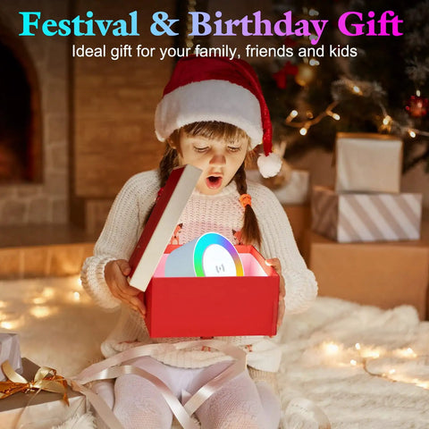Child opening gift box with 4 In 1 Night Light Bluetooth Speaker With Wireless Charging 15W, Christmas scene in background