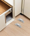 Solid Silver Copper Cabinet Door Rollers With Silent Close And Rust Resistant Finish, 10 Pack Secure Hardware For Kitchens Bathrooms And Rv Cupboards, silver rollers on wood floor near cabinet.