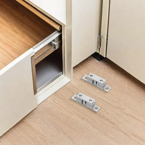 Solid Silver Copper Cabinet Door Rollers With Silent Close And Rust Resistant Finish, 10 Pack Secure Hardware For Kitchens Bathrooms And Rv Cupboards, silver rollers on wood floor near cabinet.