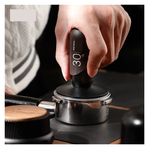 No Drama 2 In 1 Coffee Tamper And Constant Pressure Espresso Distribution Tool With Calibrated Spring For Even Powder Pressing And Flawless Puck Prep In 58mm Silver held in hand, pressing down on espresso basket.