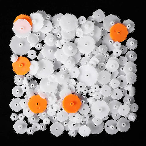 200Pcs White Plastic Gears Module 0.5 for DC Motors RC Cars DIY Models Robots Replacement Kit scattered on black background