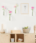 Glass Tube Propagation Station Hanging Vase Set - 4 Cylinder Wall Planters on white wall with flowers, decor below.