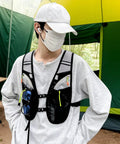 Individual wearing Hydration Vest For Outdoor Adventures With Easy Access Water Bladder System Reflective Front Chest Pocket
