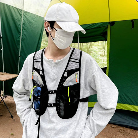 Individual wearing Hydration Vest For Outdoor Adventures With Easy Access Water Bladder System Reflective Front Chest Pocket